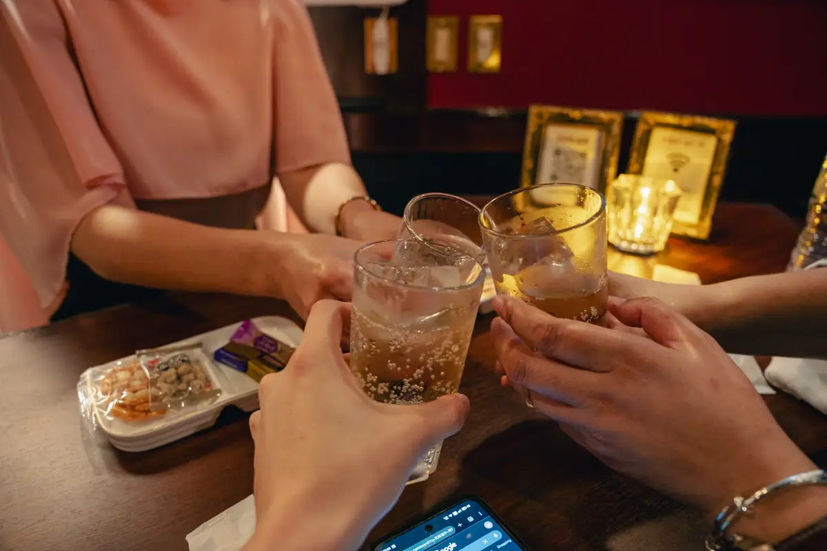 Guests toasting at a Kobe snack bar counter